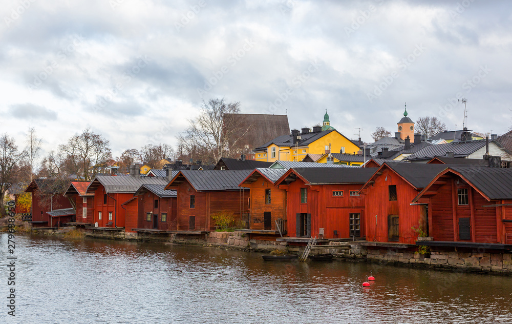 Porvoo town, Finland. Old red wooden houses on the river coast on a cloudy day Porvoo town, Finland. Old red wooden houses on the river coast on a cloudy day