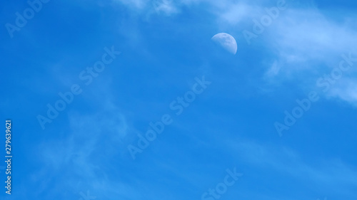 moon on a blue sky day
