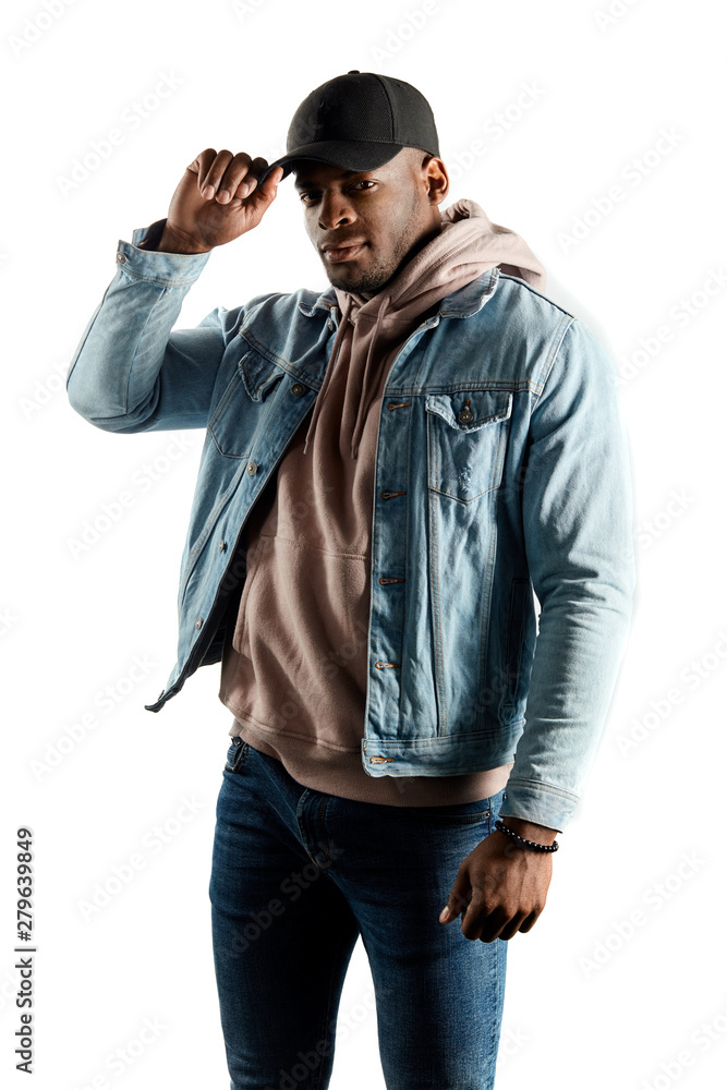 handsome young man in casual clothes holding his cap and posing to the camera, close up portrait. isolated white background. fashion, people concept handsome young man in casual clothes holding his cap and posing to the camera, close up portrait. isolated white background. fashion, people concept