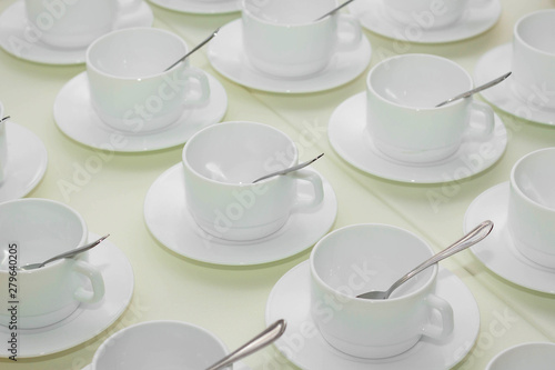 many empty white cups of tea on the table
