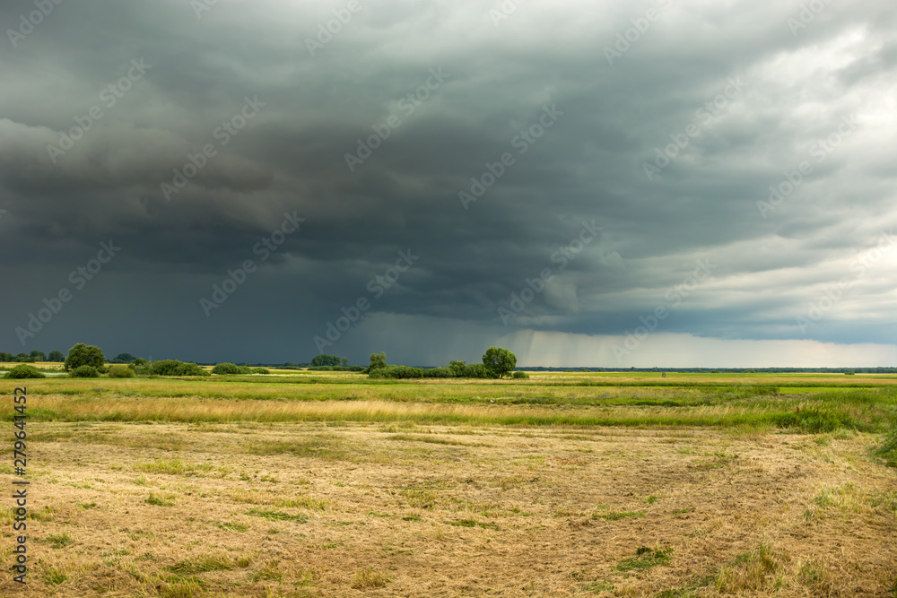 Dry field and rainy cloud
