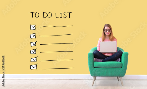 Obraz na plátne To do list with young woman using her laptop in a chair