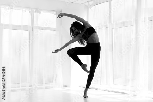 Dancer Training Modern Ballet In Studio. Black And White