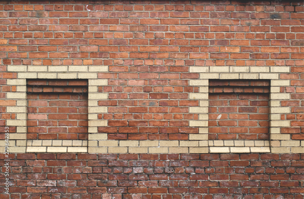 Fototapeta premium Red brick stone wall with yellow bricks to create tower shapes