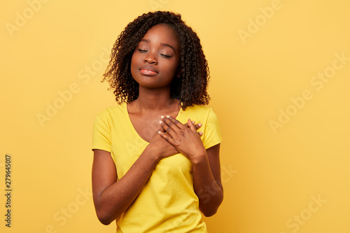 Quadro em tela dreaming girl with palms on her chest thinking about her boyfriend, strong unforgettable emotion