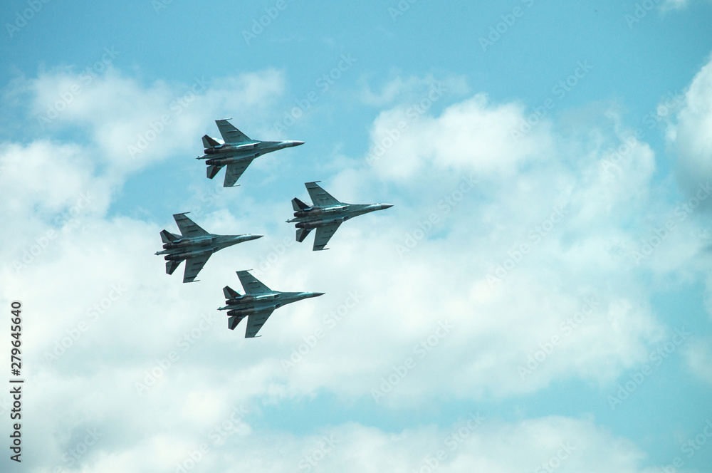 Group of four military aircraft of fighters, jet airplane in the sky make maneuvers Group of four military aircraft of fighters, jet airplane in the sky make maneuvers