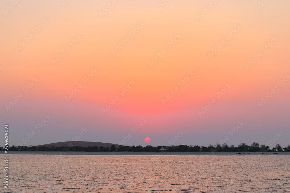 Naklejka premium SUNSET VIEW FROM SEA SHORE - BEACH BANK