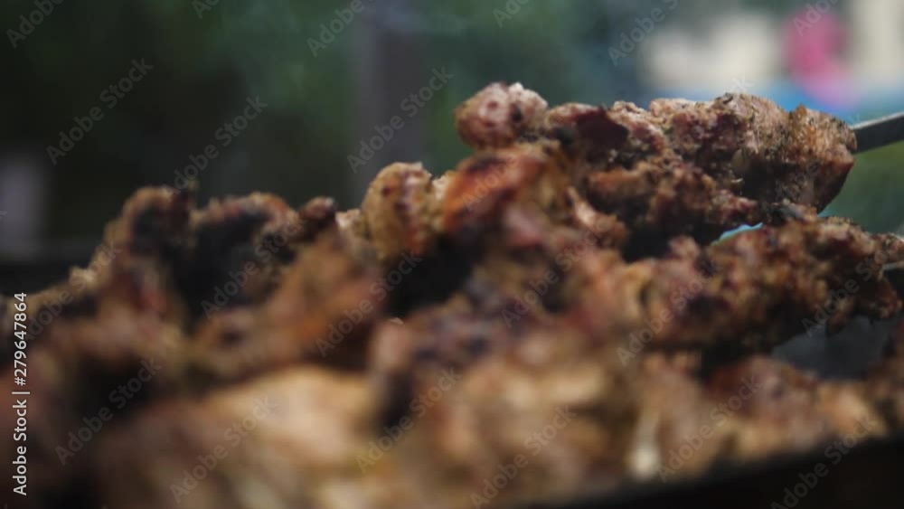 Grilling Marinated Shashlik skewered meat on a Grill BBQ. Beef prepared on fire. Barbecue party in slow motion Grilling Marinated Shashlik skewered meat on a Grill BBQ. Beef prepared on fire. Barbecue party in slow motion