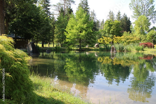 pond surrounded by trees in the park of Comano Terme (Trentino Alto Adige, Italy) photo
