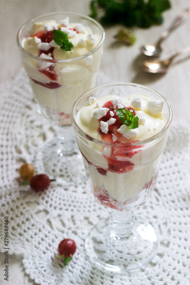 Eton mess, traditional English dessert with gooseberry, whipped cream and meringue on a light background. Rustic style. Eton mess, traditional English dessert with gooseberry, whipped cream and meringue on a light background. Rustic style.