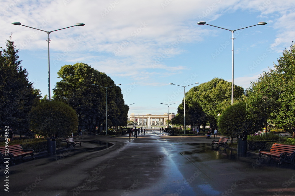 Gorky Park in Moscow, alley with street lights and the main entrance on a Sunny summer day after the rain