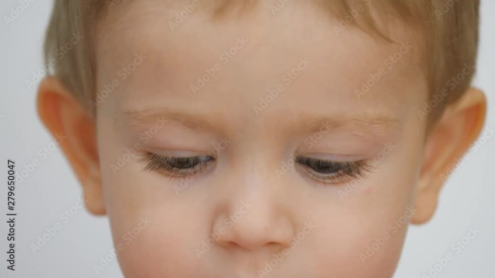 Portrait of little child with blue eyes looking down Portrait of little child with blue eyes looking down
