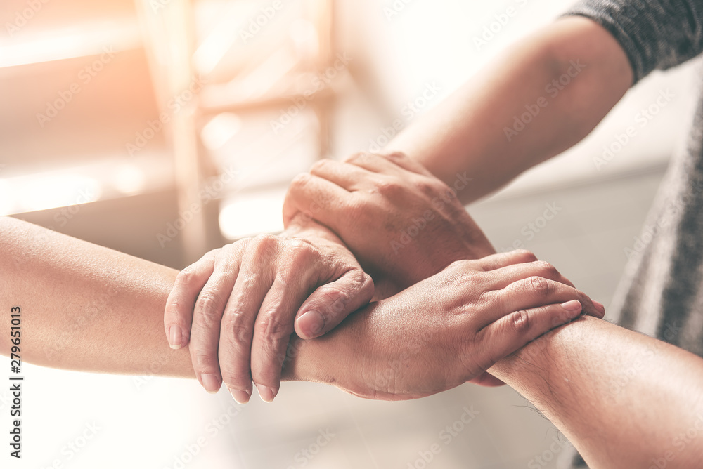 Fototapeta premium People hand assemble as a connection meeting teamwork concept. Group of people assembly hands as business or work achievement. Man and women touch each other hands after meeting. Teamwork conceptual.
