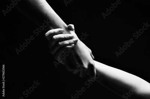 Giving a helping hand to woman on background photo