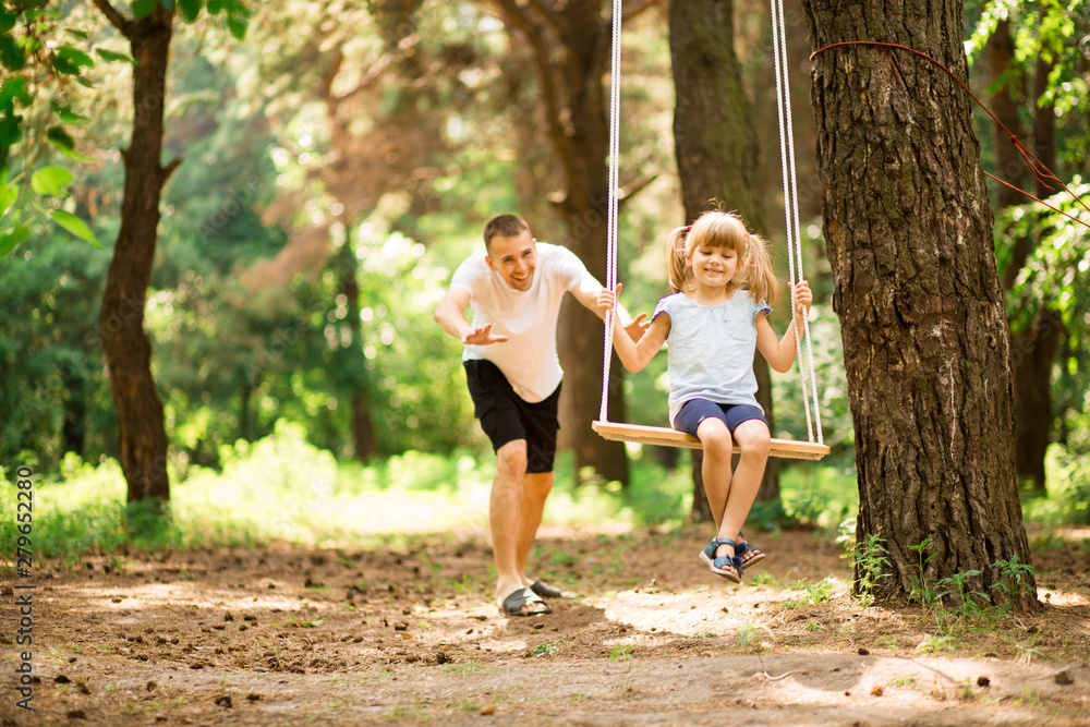 Father spends time with his cute daughter on the playground Father spends time with his cute daughter on the playground