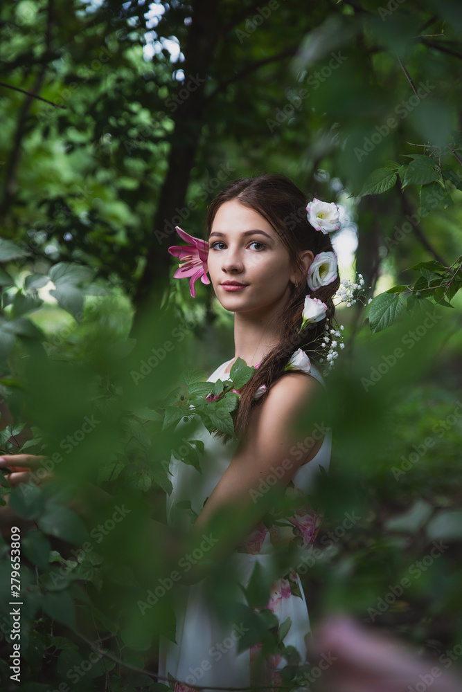 beautiful girl with lilies in her hair, flowers in the luxurious dark hair of a young lady beautiful girl with lilies in her hair, flowers in the luxurious dark hair of a young lady