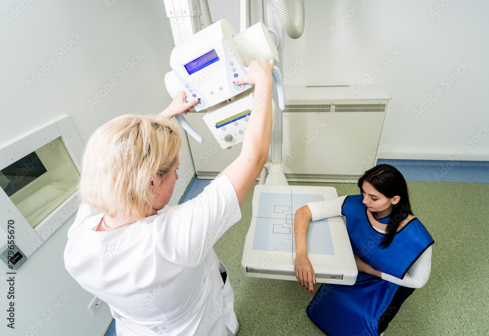 Radiologist and patient in a xray room. Xray of human hand. Classic
