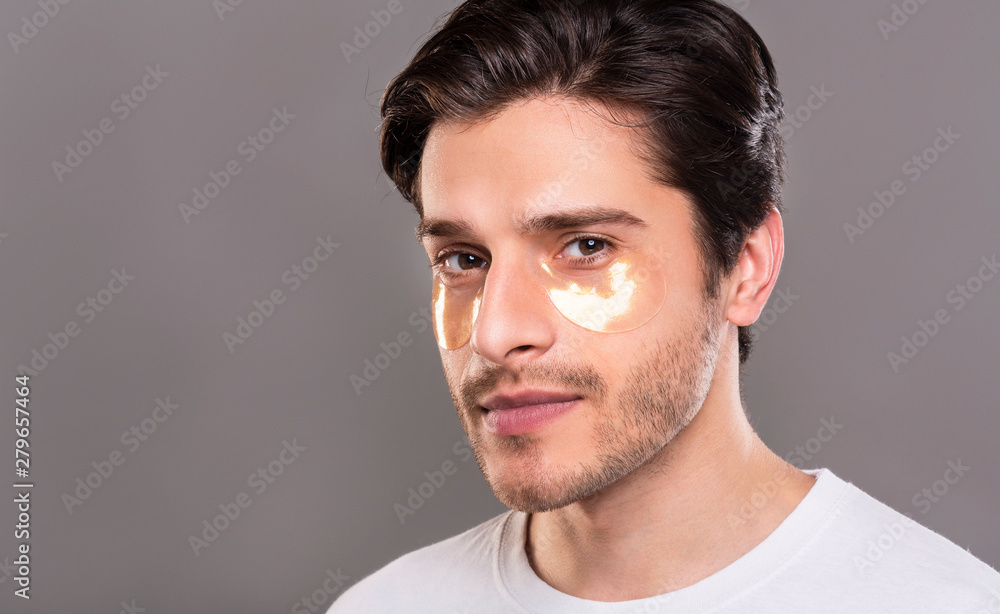 Obraz premium Man with golden eyes patches, free space