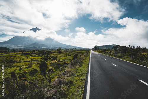 Billede på lærred Straight EN3 longitudinal road northeast of Mount Pico and the silhouette of the Mount Pico along , Pico island, Azores, Portugal