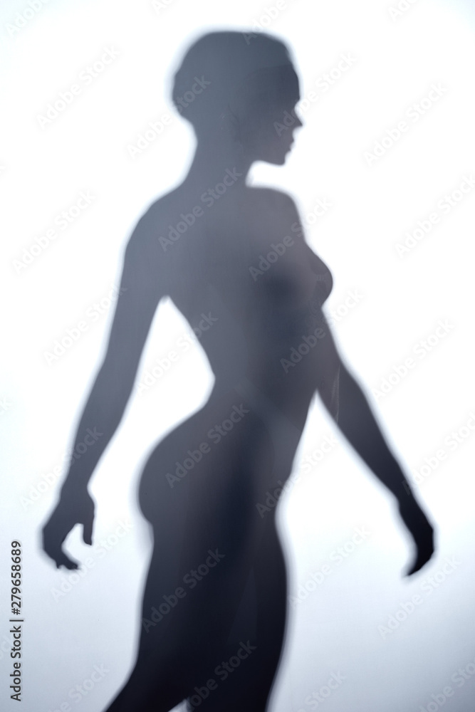young woman with short hair walking behind the glass wall. close up photo.relaxation concept