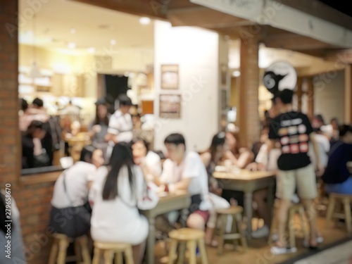 blurred image of People in coffee shop or cafe restaurant with abstract bokeh light image background.For montage product display or vintage tone and light effect