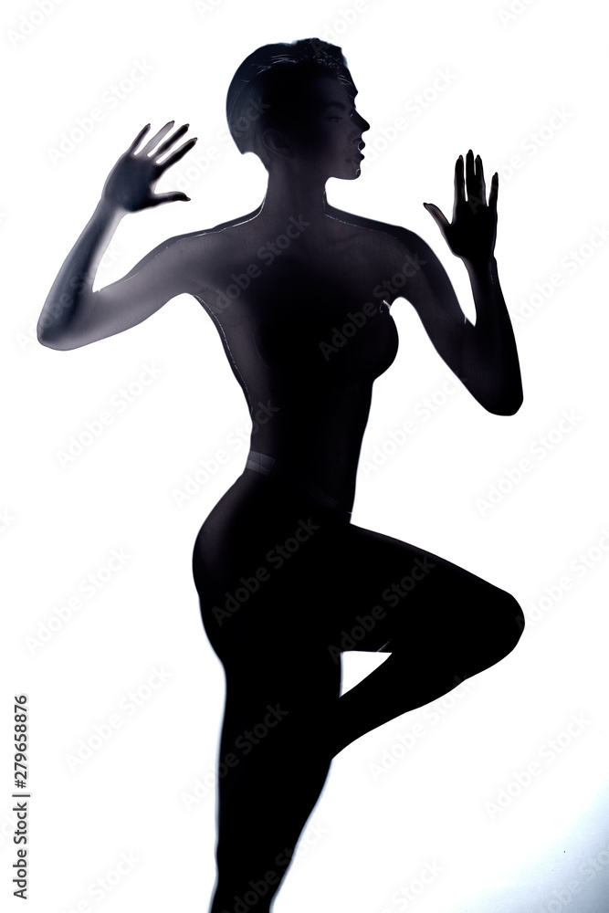 black silhouette of girl standing behind the glass, close up photo. black silhouette of girl standing behind the glass, close up photo.