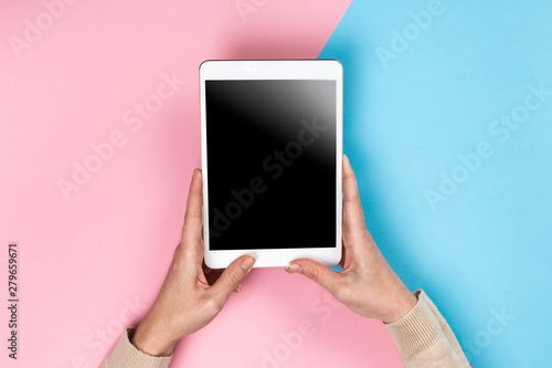 Closeup shot of  Woman's hands with perfect manicure  holding tablet, Empty display device. with clipping path.