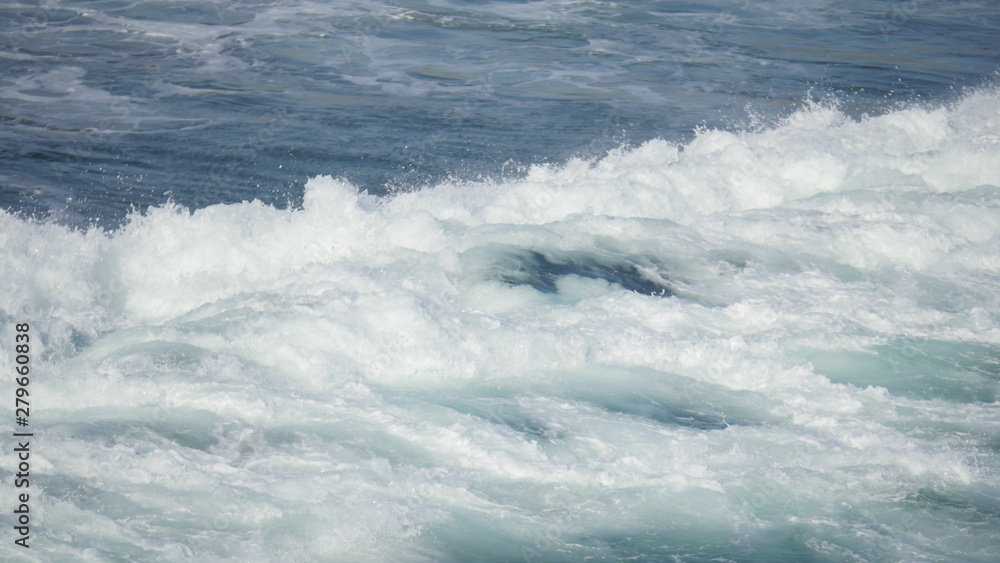 Beach with waves crashing at the ocean shot in high resolution 