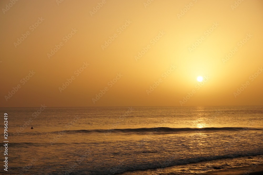 an orange sunset with waves