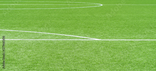 Green artificial grass soccer sports field with white stripe lines