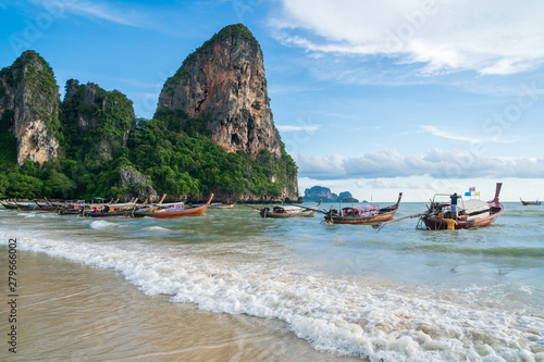 Beautiful tropical railay beach with Thai traditional wooden longtail boat at Krabi, Thailand © Kittiphan