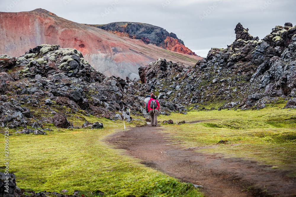 Colorful rainbow rhyolite volcanic mountains Landmannalaugar as pure wilderness in Iceland and hikers, summer time