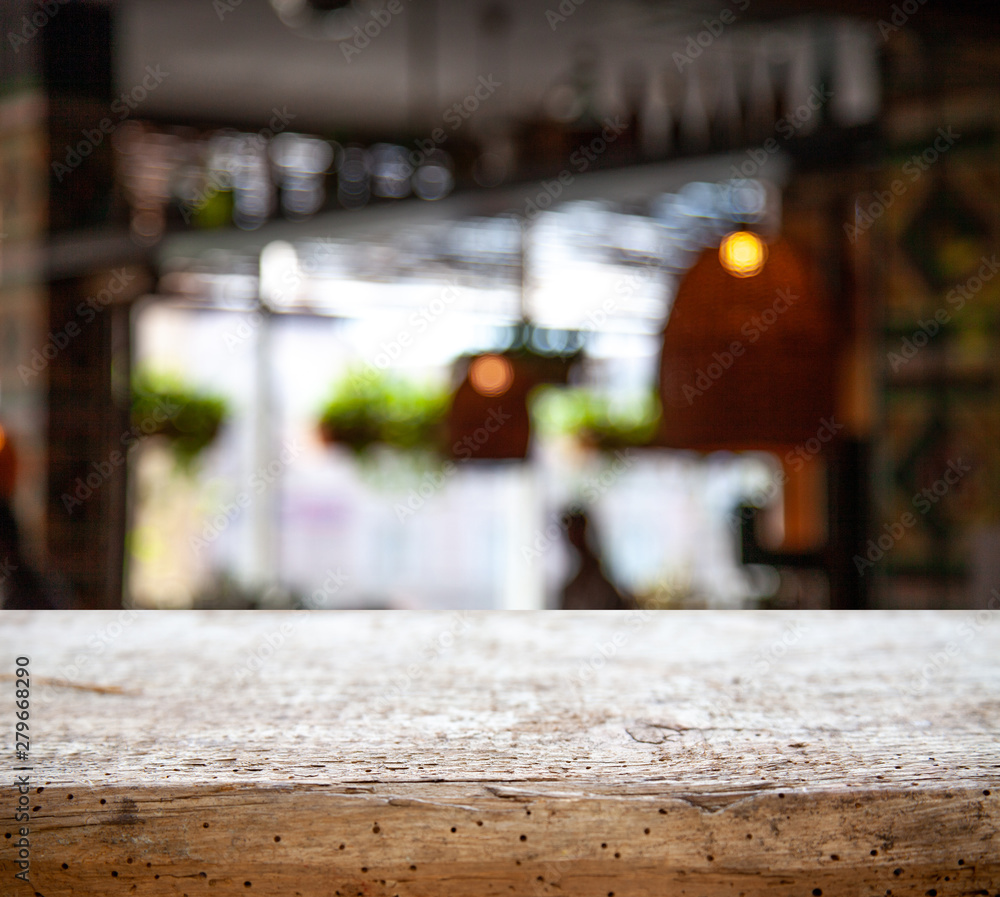 wooden table on blurred lightbulb cafe background