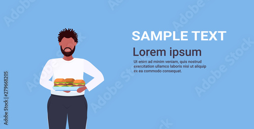 fat overweight man holding tray with hamburgers unhealthy lifestyle concept obese guy eating fast food over size male cartoon character portrait flat horizontal copy space