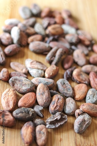 cocoa beans on a wooden surfaceb ingredient for vegetarian food photo