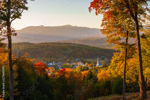 Overlooking a peaceful New England village in the autumn at sunset.