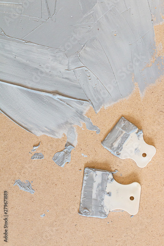 Renovating equipment isolated on wooden background. Putty-knife pattern