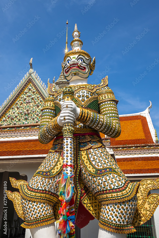 Fototapeta premium Bangkok, Thailand at Wat Arun Temple, Giant Statue guarding the entrance to the temple, Bangkok, Thailand. on the Thonburi west bank of the Chao Phraya River.