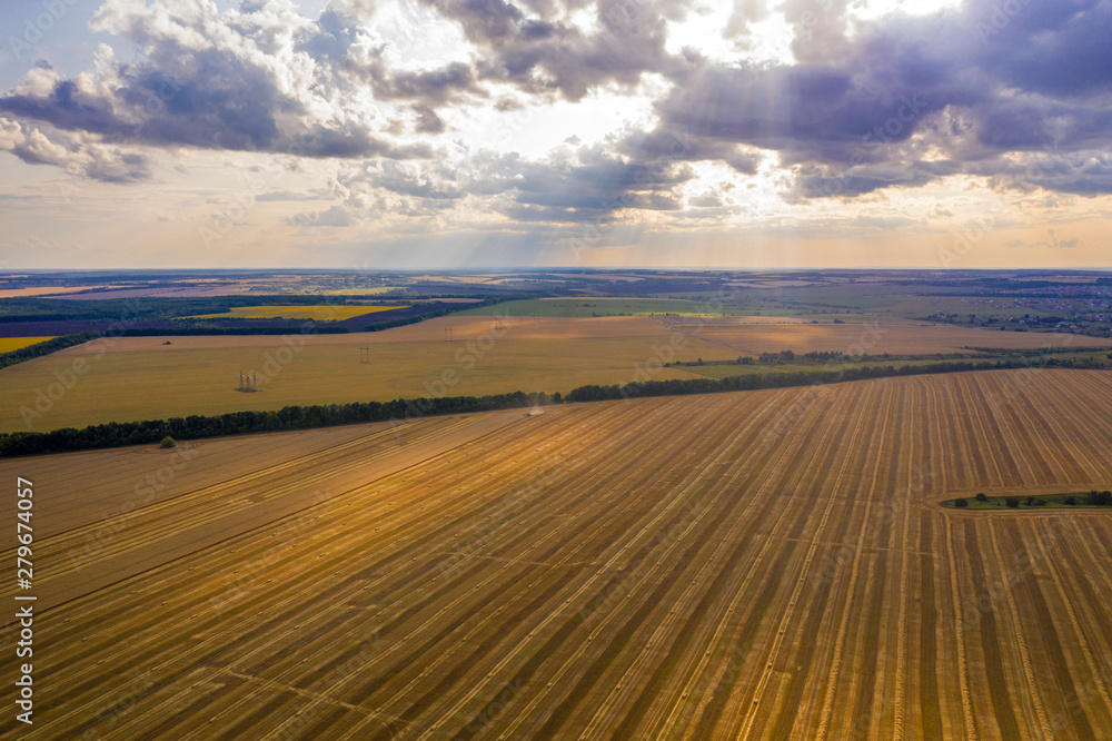 fields of mown wheat going into the distance, view from the quadcopter