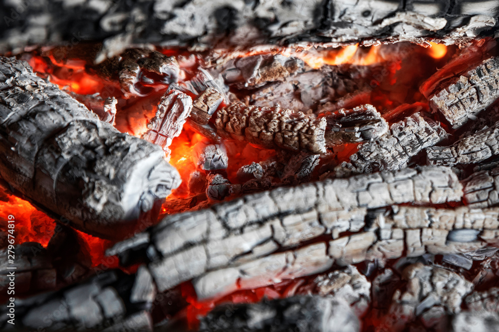 bright red-orange coals of heat from a burnt tree close up, background. bright red-orange coals of heat from a burnt tree close up, background.