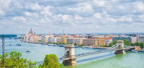 Cityscape of Budapest with parliament building and chain bridge.