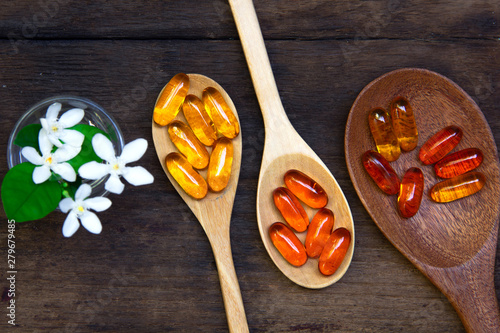 Omega 3 fish oil capsules  for good brain , heart and health. place on old  wooden plat.