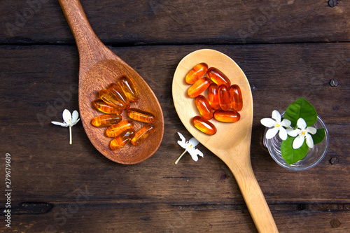 Omega 3 fish oil capsules  for good brain , heart and health. place on old  wooden plat.
