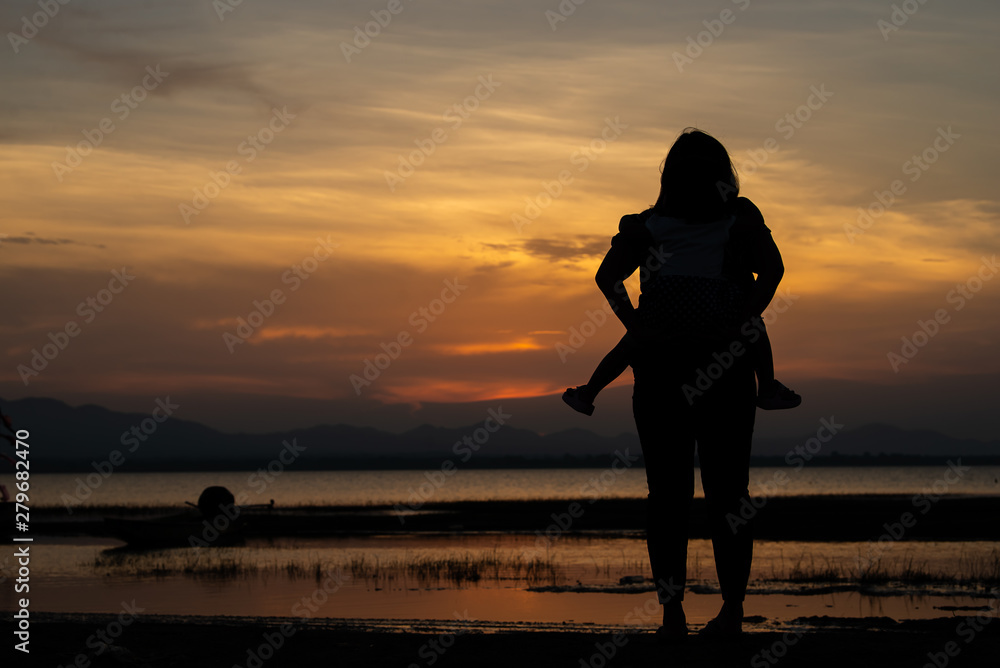 Silhouette of mother and daughter on sunset,Thailand people,Happy family concept,Mother day concept