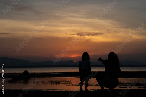 Silhouette of mother and daughter on sunset,Thailand people,Happy family concept,Mother day concept