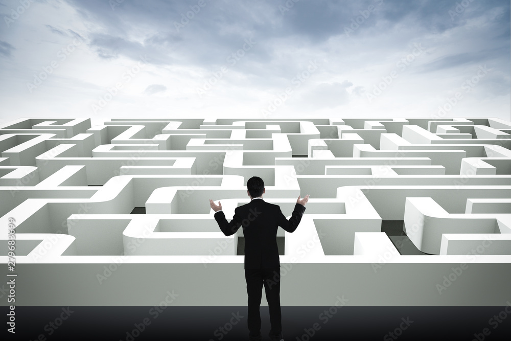 Businessman going straight ahead on a wide road between mazes Businessman going straight ahead on a wide road between mazes