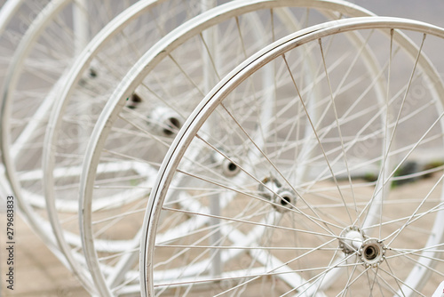 Bicycle wheels with spokes in a perspective as decor © Lazy_Bear