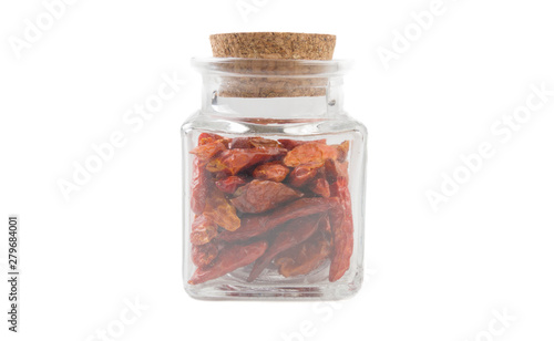 chili peperoncini paprika pepper in glass  jar on isolated on white background. front view. spices and food ingredients.