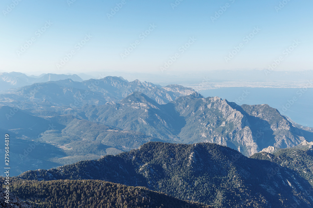 Obraz premium Beautiful landscape in the mountains. Lovely view of the Taurus Mountains and the Mediterranean coast from the top of mount Tahtali. Kemer, Turkey. Postcard view