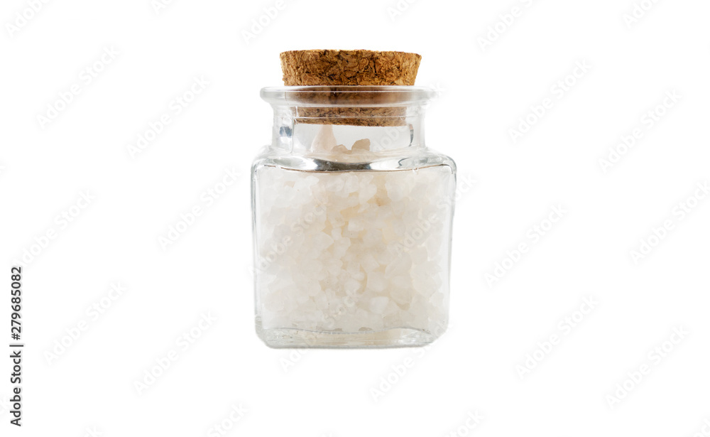 white salt crystals in glass jar on isolated on white background. front view. spices and food ingredients. white salt crystals in glass jar on isolated on white background. front view. spices and food ingredients.